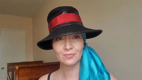 wearing a scarf under hat.